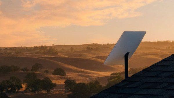 A white solar panel sitting on top of a roof.
